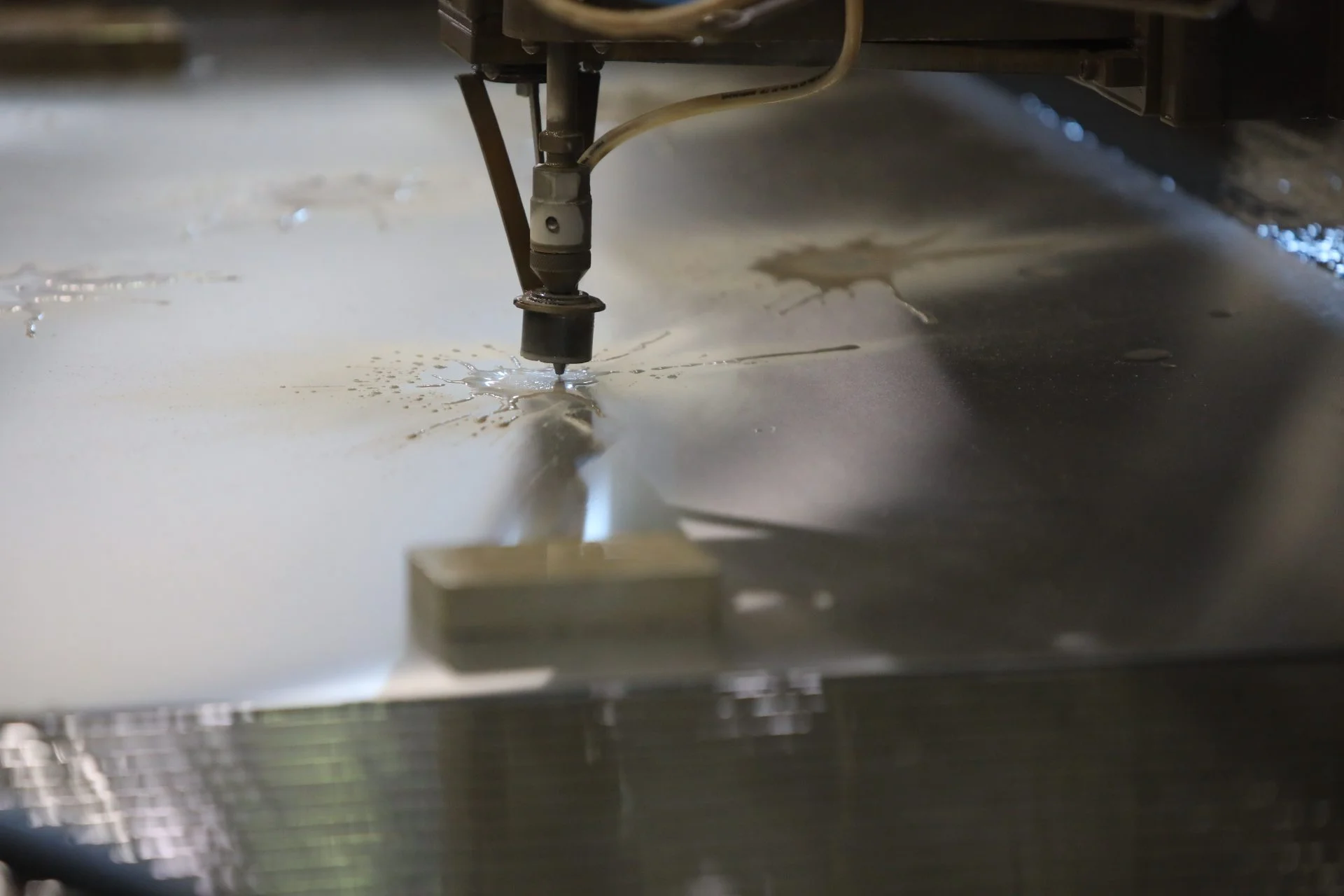 A water jet cutter cutting glass.